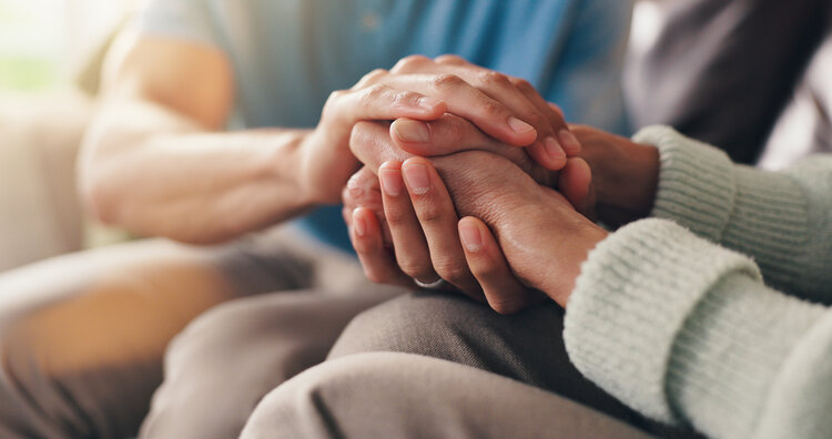 Hands clasped in a supportive gesture, representing compassionate case management.