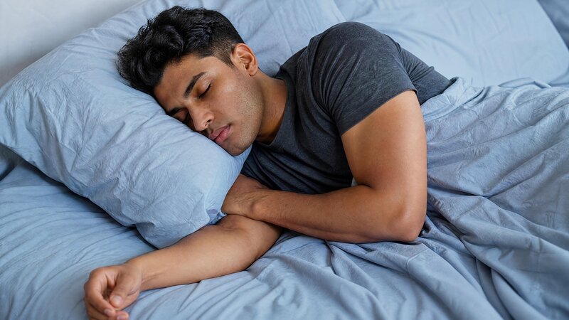 Neuroplasticity After Brain Injury: 8 Proven Ways to Support Recovery - Young man sleeping on blue sheets